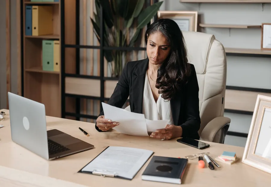 A professional reviewing documents at a desk